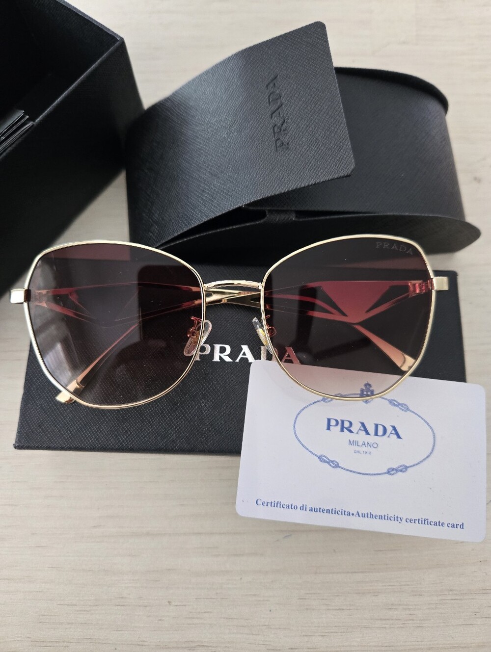 Prada Women's Gold Frame Sunglasses with Pink Gradient Lenses